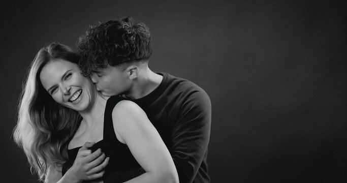 Young couple showing intimacy and happiness with a kiss on the neck