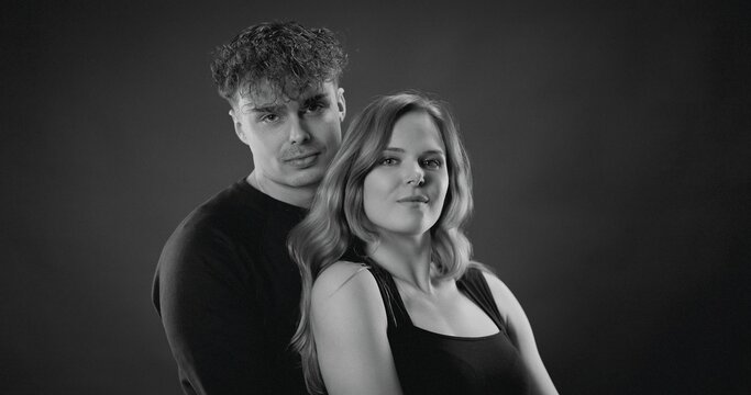 Man holding woman in studio, representing relationship, love, and intimacy