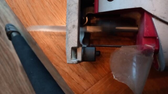 Close up view of a reciprocating saw showcasing cutting action and motor revs in a home workshop setting