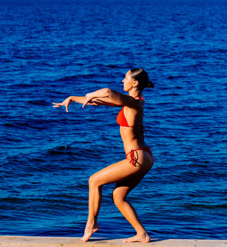 Young woman in swimwear standing near the ocean in wa USA