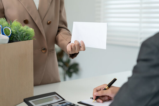 resignation, leave, quit, employee pass on resignation letter to Business owner . staff is lifting a brown paper box that holds personal items. , job placement and vacancies, resignation letter