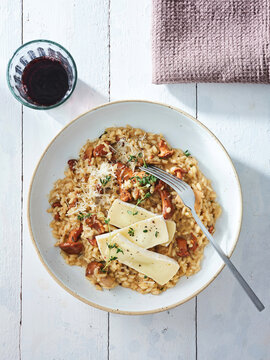 Mushroom risotto with grated cheese and a glass of red wine, fine dining experience for memorable occasions