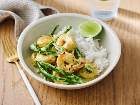 Shrimp and green bean curry with steamed rice and lime, Asian-inspired menu, flavorful meal option