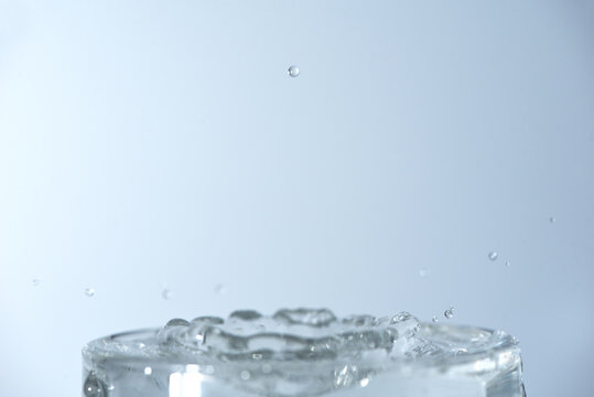 photo of water splashing in a glass