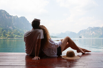 Fototapeta premium Couple relaxing by serene lake.