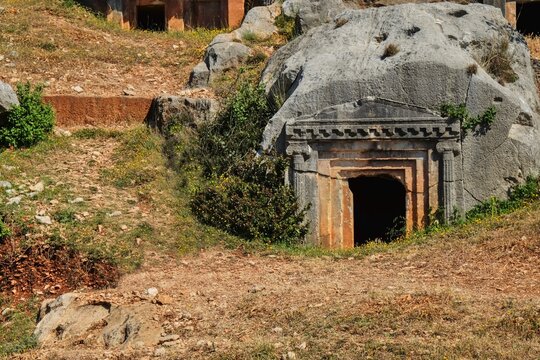 Ancient Lycian rock-cut tomb carved into limestone cliff at Myra archaeological site near Demre, Turkey