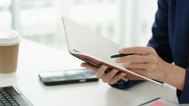 Financial admin reviewing data at worktable in professional office