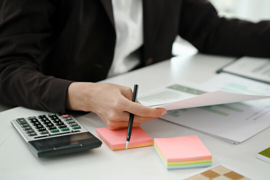 Financial admin reviewing data at worktable in professional office