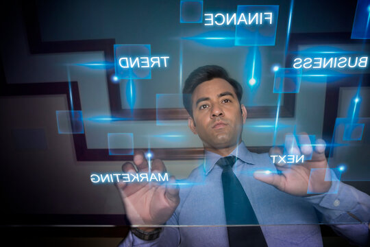 Businessman using futuristic computer keyboard