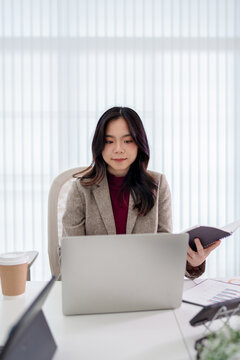 Business administrator reviewing financial reports and marketing analysis for company sales growth and strategy development