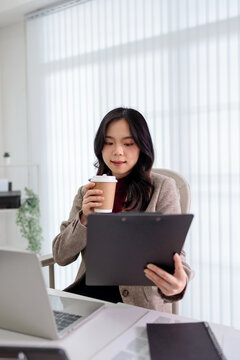 Business administrator reviewing financial reports and marketing analysis for company sales growth and strategy development