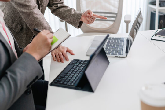 Business administrator reviewing financial reports and marketing analysis for company sales growth and strategy development
