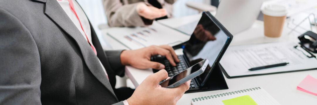 Business administrator reviewing financial reports and marketing analysis for company sales growth and strategy development