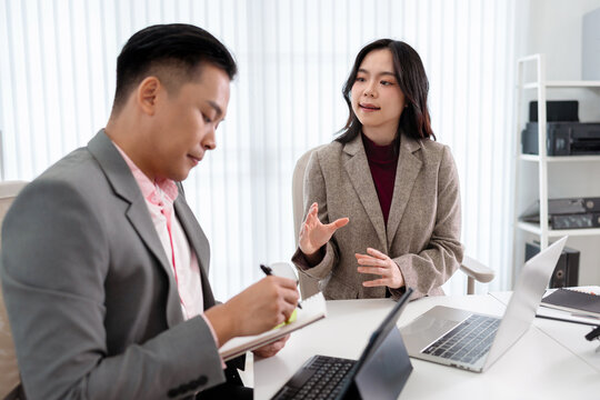 Business administrator reviewing financial reports and marketing analysis for company sales growth and strategy development