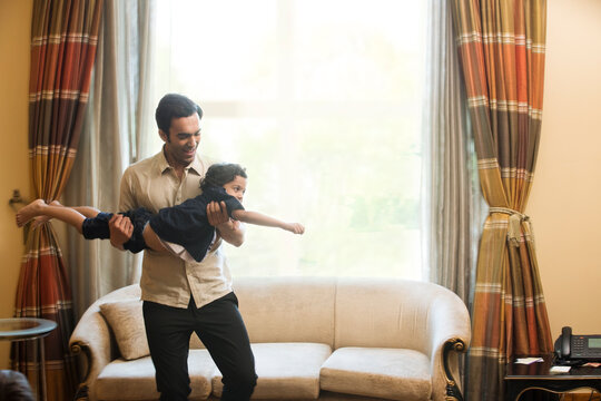 Father holding son like a plane