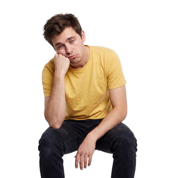 bored young man transparent background exhausted sitting head hand fatigue Weary man rests his face on one palm with an expression in a seated pose for burnout monotony education and workplace layouts