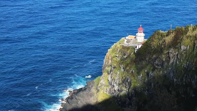 Lighthouse on the cliff at Terseira island Azores Portugal