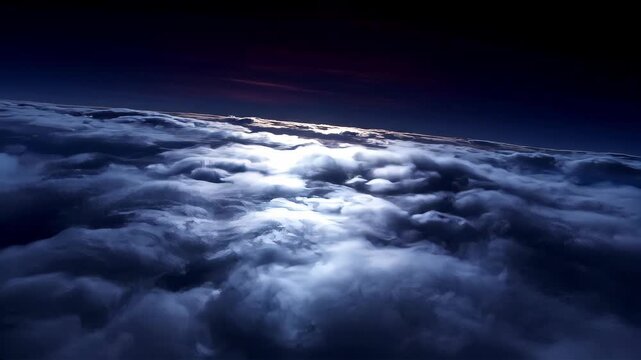 Aerial view of a night landscape with moonlight reflecting on clouds. Dark sky above thick cloud cover moving in a night sky. Cinematic travel flight concept.