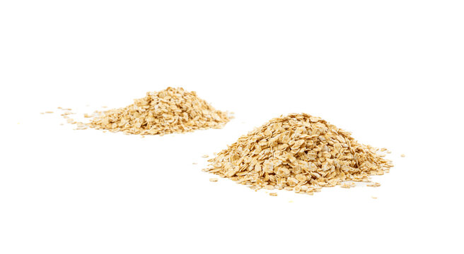 Dry raw oat flakes isolated, rolled flat grains, instant porridge, thin cereals, flattened grains group