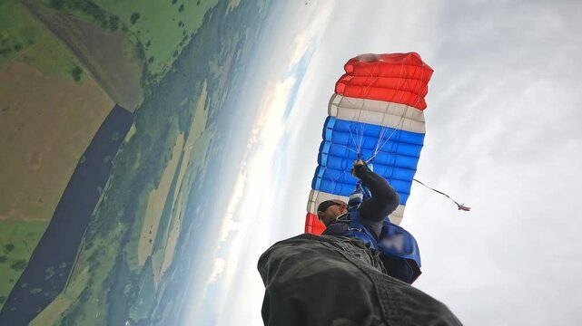 An action camera view of a skydiver performing a turn under a sports dome. Extreme sports, altitude, speed and adrenaline.
