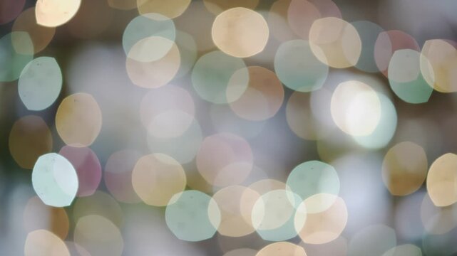 Colorful bokeh lights gradually shift in focus and intensity, creating a vibrant and dynamic visual effect in a softly blurred background setting
