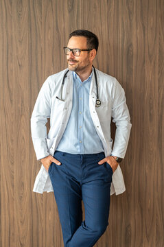 Healthcare provider standing against a patterned wall, embodying professionalism and dedication while offering expert medical advice and support to patients