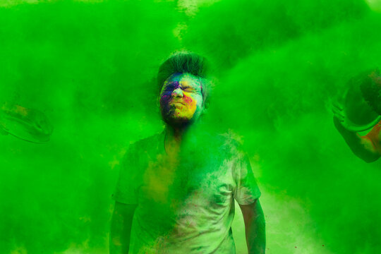 Young man with holi colors