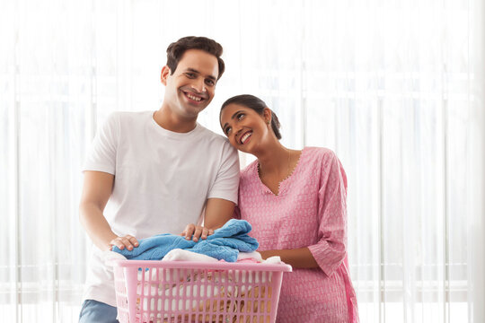 Smiling couple doing laundry