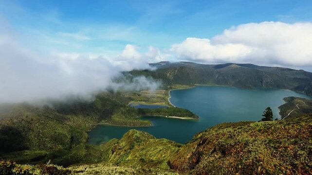 Lagoa do Fogo Sao Miguel island in Azores fog flying over the lake view from the mountain Portugal