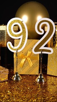 Gold Number 92 with Gold Glitter Confetti Sparkles with Gifts and Balloons for Party Ninety Two Vertical 4K