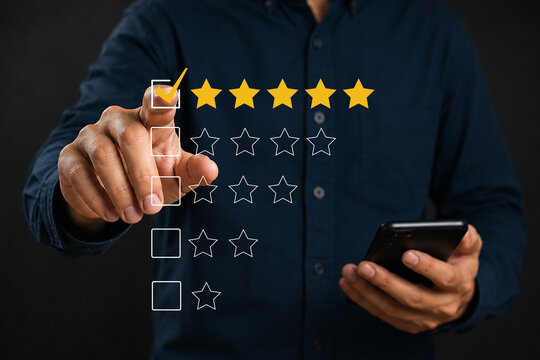 Hand selecting five stars on black background, representing customer satisfaction, positive reviews, quality evaluation, and excellent product and service ratings. 
