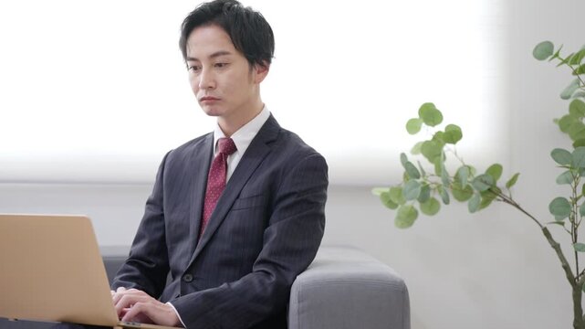 パソコンで仕事するビジネスマン男性