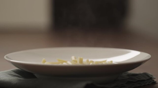 Slow motion hot penne pasta in deep plate closeup
