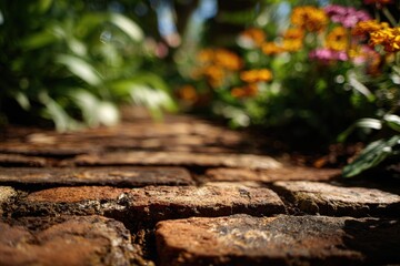 Fototapeta premium Brick path winding through a summer garden. Old rustic walkway made of clay tiles surrounded by blooming flowers. Peaceful meadow landscape showing nature, landscaping and outdoor design.