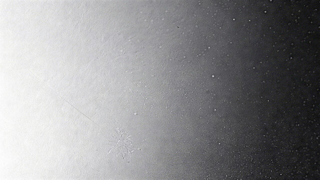 Silver gray monochrome film grain texture with soft vignette shading
