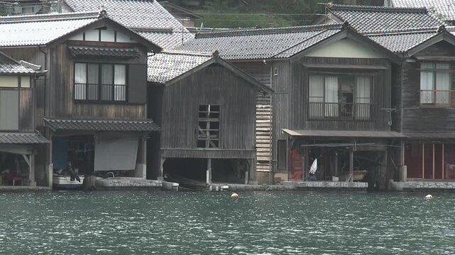 A static close-up shot of a *funaya* (boat house) in Ine Town, Kyoto Prefecture.