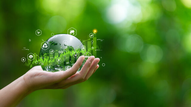 ESG investing, green finance and renewable energy investment concept. glass globe with environmental responsibility icon in hand for sustainable investment, clean energy, decarbonization