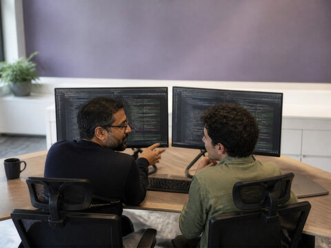 Developers collaborating with AI coding assistant
