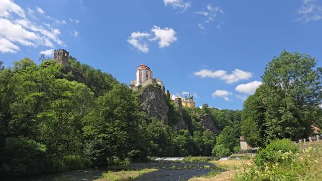 Beautiful timelapse of Vranov nad Dyj&iacute; Castle, a magnificent Baroque landmark in South Moravia, Czech Republic. Perched dramatically on a rocky cliff above lush forests under a blue summer sky with dr
