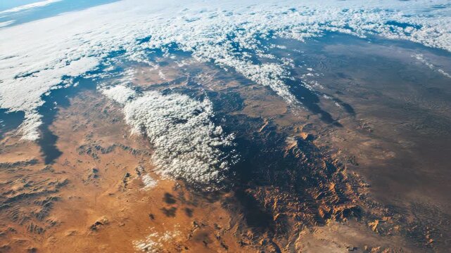 An aerial perspective of a vast sandy expanse under clear skies