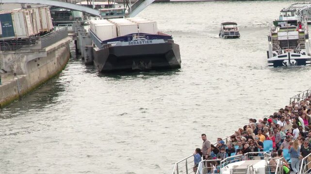 Crowded Tourist Boat Cruising the Seine River in Paris France