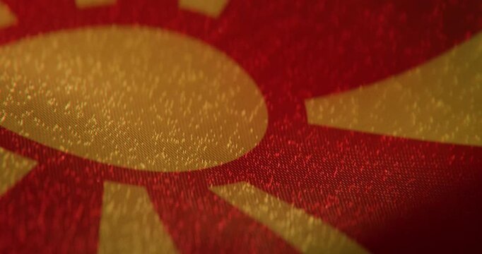High quality 4K seamless loop of the North Macedonian national flag waving in slow motion. Detailed cloth fabric texture, yellow sun, and smooth wave motion for culture, news, and national events.
