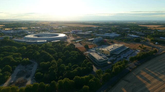 Aerial view of modern circular synchrotron particle accelerator and scientific research facility in Oxfordshire UK
