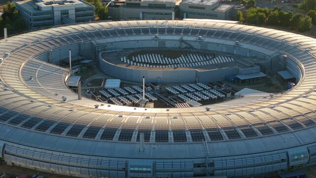 Aerial view of modern circular synchrotron particle accelerator and scientific research facility in Oxfordshire UK