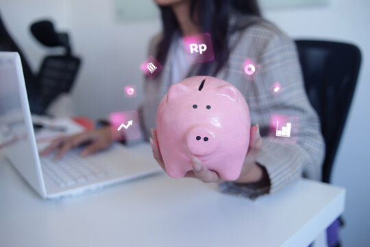 Professional Executive Holding Piggy Bank And Using Laptop To Track Digital Investments
