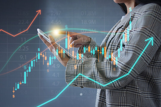 Female Investor Using Digital Tablet To Track Rising Stock Hologram