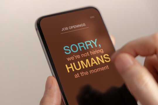 Smartphone showing a job rejection message, illustrating AI disruption, automation, unemployment