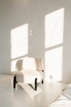 Modern White Armchair With Black Legs In Bright Studio Interior