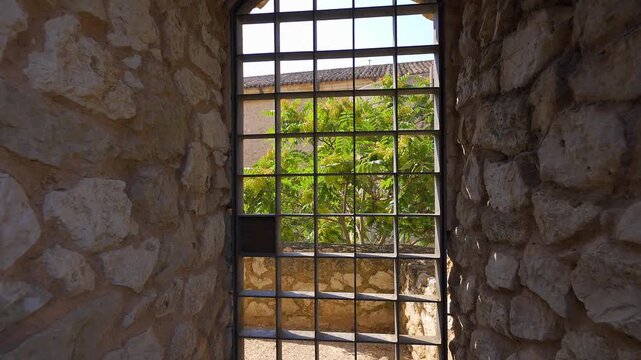 Iron gate beneath a stone vaulted doorway inside Cuenca Castle in Castilla La Mancha