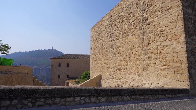 Massive stone walls and historic buildings at Cuenca Castle in Cuenca Spain